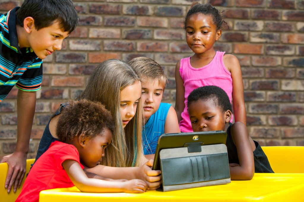 A group of young children sitting next to a child